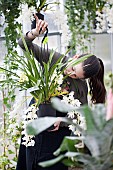 Young girl working in garden centre.