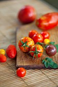 Tomato, Lycopersicon esculentum , Studio shot or red tomoatoes on wooden board.