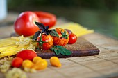 Tomato, Lycopersicon esculentum , Studio shot or red tomoatoes on wooden board.