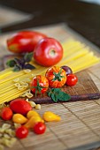 Tomato, Lycopersicon esculentum , Studio shot or red tomoatoes on wooden board.