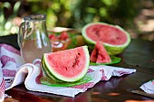 Watermelon, Citrulus lanatus, Outdoor shot of sliced fruit showing red flesh and seed,