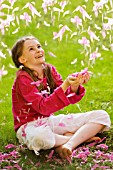 YOUNG GIRL CATCHING PETALS