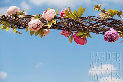Rose_Rosa_Hanging_floral_decorations_weaved_into_a_wicker_lattice