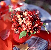 ARRANGEMENT OF ROSEHIPS, SMALL ROSES AND APPLES