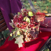 BERRIES, LEAVES AND BLOSSOMS IN A BASKET