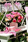BOUQUET OF ROSES IN A PINK BUCKET ON THE BALCONY -