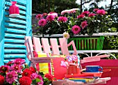 SEATING AREA ON A BALCONY WITH DAHLIAS IN WINDOW BOXES