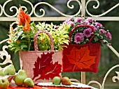 A DISPLAY OF AUTUMNAL PLANTS IN BASKET CONTAINERS