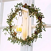 WREATH HANGING WITH BERRIES AND CONES