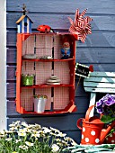 PAINTED FRUIT BOX AS SHELF IN THE GARDEN