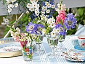 MIXED SUMMER FLOWERS IN GLASSES