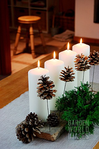 CHRISTMAS_DECORATION_WITH_CANDLES_FIR_BRANCHES_AND_FIR_CONES