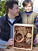 INSECT HOUSE BUILDING PROJECT WITH FATHER AND SON.  THE FINISHED ARTICLE WITH PROUD BUILDERS.  STEP 33
