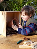 INSECT HOUSE BUILDING PROJECT WITH FATHER AND SON.  PLACING POT IN BOX   STEP 13