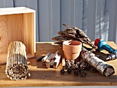 INSECT HOUSE BUILDING PROJECT WITH FATHER AND SON.  MATERIALS READY FOR MAKING BUG HOTEL  STEP 3