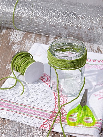 UPCYCLING_OLD_JAM_JARS_CREATING_POSIE_HOLDER_FOR_FLOWERS_WRAPPING_STRING_AROUND_JAR