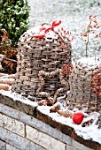 LARGE WICKER BELLS DECORATED WITH PINE CONES  ROSE HIP BRANCHES OF ROSA MULTIFLORA AND RED CHRISTMAS BALLS