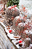 LARGE WICKER BELLS DECORATED WITH PINE CONES  ROSE HIP BRANCHES OF ROSA MULTIFLORA AND RED CHRISTMAS BALLS