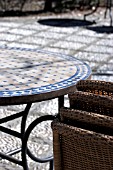 PATIO WITH STACKED WICKER CHAIRS AND TABLE