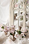 STILL LIFE OF APPLE BLOSSOM IN SPRING WITH SILVER CANDLE STICK IN FRONT OF GOTHIC MIRROR