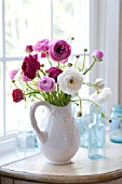 RANUNCULUS ASIATICUS IN WHITE PITCHER