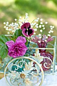 ROSA RUGOSA, CONVALLARIA MAJALIS AND PANSY ARRANGED IN ORNAMENTAL PLANTER.