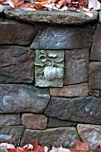 STONE WALL WITH DECORATIVE RELIEF INSET OF FRUIT
