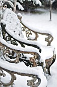 WEATHERED CAST IRON ORNATE GARDEN CHAIRS IN SNOW