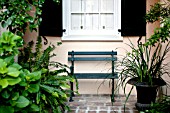 BRICK WALKWAY WITH BENCH IN GARDEN COURTYARD