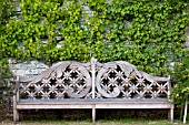 WOODEN BENCH IN FORMAL FRENCH GARDEN