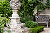 BUXUS SEMPERVIRENS, BOXWOOD AND WOODEN BENCH AT CHATEAU DE BRECY