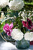 VIBURNUM OPULUS ROSEUM (STERILE),  ROSA RUGOSA HANSA, CONVALLARIA MAJALIS AND PANSY ARRANGED IN VASES