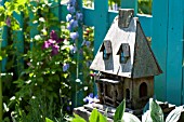 DECORATIVE BIRD HOUSE IN SUMMER COTTAGE GARDEN