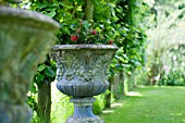 DECORATIVE PAINTED URN IN CLASSICAL GARDEN UNDER GRAPE ARBOUR