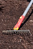 RAKING FINE TILTH SOIL FOR ANNUAL SOWING