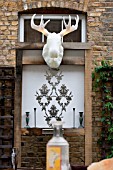 THE DRAWING ROOM GARDEN  URBAN LONDON GARDEN  WATER FEATURE AND ILLUMINATED MOOSE HEAD WITH FILIGREE PATTERN WALL PLAQUE  DESIGNED BY: EARTH DESIGNS.