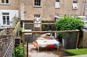 THE DRAWING ROOM GARDEN  URBAN LONDON GARDEN  ELEVATED VIEW  THE SEATING AREA  WITH THE ILLUMINATED MOOSE HEAD TROPHY AND THE WATER FEATURE   DESIGNED BY: EARTH DESIGNS.