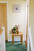 FRESH FLOWER ARRANGEMENT IN HALLWAY