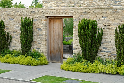 LOOKING_THROUGH_DOORWAY_INTO_WALLED_KITCHEN_GARDEN_WITH_TAXUS_BACCATA_AND_ALCHEMILLA_MOLLIS