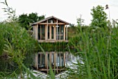 WOODEN SUMMERHOUSE BY POND