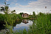 WOODEN SUMMERHOUSE BY POND