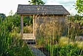 WOODEN GARDEN SUMMERHOUSE WITH STIPA GIGANTEA