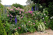 BORDER OF ROSES, DELPHINIUMS AND PHILADELPHUS AT HANHAM COURT