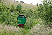 GYPSY CARAVAN IN MEADOW AT HANHAM COURT