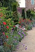 GARDEN SEAT IN LATE SUMMER BORDER AT HANHAM COURT