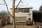 WINTER SHED WITH SEAT AND OLD LAWN ROLLER