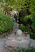 PATH AND STEPS IN COUNTRY GARDEN WITH STONE BALL AND URNS