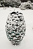 METAL-WORK SCULPTURE COVERED IN SNOW