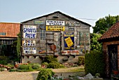 OLD SIGNS ON GARDEN OUTBUILDING AT 21 CHAPEL STREET, HACONBY, LINCS