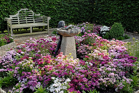 STATUE_OF_LITTLE_GIRL_AND_WATER_FEATURE_SURROUNDED_BY_DIANTHUS_BARBATUS_SWEET_WILLIAMS